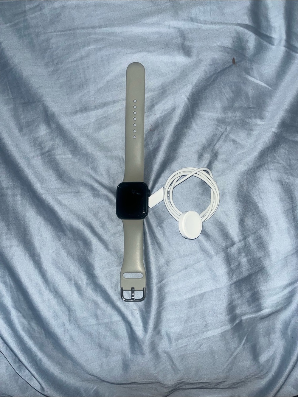 Apple Watch with Beige Sport Band and White Charger